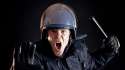 Angry-police-officer-with-nightstick-via-Shutterstock.jpg