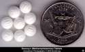 Color photo of Desoxyn brand Meth tablets next to a quarter for size comparison. U.S., 2002.jpg