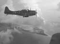 A_Douglas_SBD_Dive_Bomber_over_Wake_Island,_1943.jpg