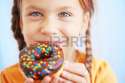 15070051-cute-kid-girl-eating-sweet-donuts.jpg