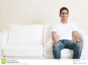 lonely-single-asian-man-sitting-couch-young-indian-guy-sofa-smiling-lifestyle-home-handsome-male-model-65067803.jpg