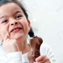 31919565-Girl-holding-chocolate-Easter-Bunny-with-its-ear-bitten-off-Stock-Photo.jpg