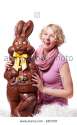 girl-laughing-and-holding-a-huge-chocolate-easter-bunny-isolated-on-E8EM38.jpg