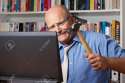 25745346-Furious-man-with-bald-patch-hitting-his-computer-with-a-hammer-Stock-Photo.jpg