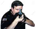 354483-Police-officer-pointing-a-weapon--Stock-Photo.jpg