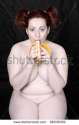 stock-photo-naked-overweight-woman-eating-fresh-ripe-bananas-on-black-background-funny-image-fine-art-style-66536302.jpg