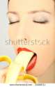 stock-photo-young-woman-eating-banana-35089711.jpg