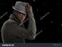 stock-photo-handsome-black-man-in-a-nice-sweater-and-fedora-hat-looks-to-the-camera-as-he-raises-his-hat-off-116875357.jpg