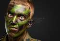 17692674-closeup-of-angry-soldier-with-painting-against-a-black-background.jpg