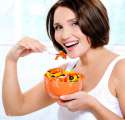 5854324-Beautiful-smiling-young-woman-eats-vegetable-salad-Stock-Photo.jpg