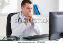 stock-photo-thinking-young-doctor-looking-at-his-screen-87353342.jpg