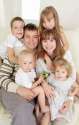 9626477-Happy-family-with-four-children-on-sofa-Stock-Photo-big.jpg