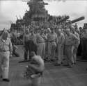 Team members of the American battleship 'New Jersey' watching bathing Japanese prisoner of war.jpg