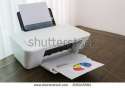 stock-photo-printer-with-financial-documents-on-a-wood-table-206045584.jpg