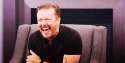 Ricky-Gervais-Cracking-Up-On-Sofa.gif