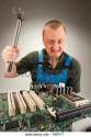 mad-it-worker-repairing-computer-circuits-by-hammer-f667yt[1].jpg