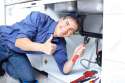8255786-Mature-plumber-fixing-a-sink-at-kitchen--Stock-Photo-plumber-plumbing-work.jpg