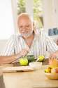 happy-senior-man-having-tea-kitchen-16618229.jpg