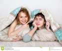 young-beautiful-couple-under-lanket-bed-24504384.jpg