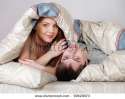 stock-photo-young-beautiful-couple-under-a-blanket-in-a-bed-99628973.jpg