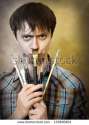 stock-photo-the-young-man-jokes-with-art-brushes-133600604.jpg