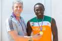 Niger rower Hamadou Issaka is presented with a medal on behalf of the Daily MIrror by Journalist Jeremey Armstrong.jpg