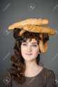 19558826-baker-girl-with-bread-on-head-Stock-Photo.jpg