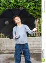 raining-teenage-boy-outside-holding-black-umbrelaa-over-him-holding-his-left-hand-out-to-feel-whether-33231445.jpg
