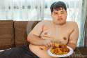 asian-fat-man-eating-fried-chicken-58225868.jpg