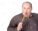 15869789-Fat-obese-man-enjoying-a-a-long-colourful-striped-lollipop-Stock-Photo.jpg