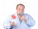 15211019-Fat-Man-in-a-Blue-Shirt-Eating-a-Lollipop-isolated-Stock-Photo.jpg
