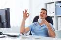 41668573-Young-man-drinking-coffee-in-the-office-and-doing-ok-gesture-Stock-Photo.jpg