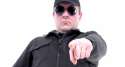 Policeman-wearing-black-uniform-and-glasses-pointing-in-ordering-manner-Shutterstock-800x430.png