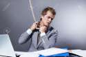 8177145-A-young-businessman-tightens-the-noose-on-Stock-Photo.jpg