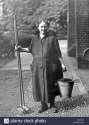 old-woman-with-bucket-and-broom-historic-photograph-around-1913-BRRYWY.jpg