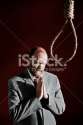 stock-photo-14224124-man-prays-before-dangling-hangman-s-noose-suicide-or-grim-discovery.jpg