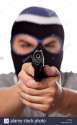 an-angry-looking-man-wearing-a-ski-mask-pointing-a-black-handgun-at-C70500.jpg