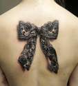 Black-And-Grey-3D-Lace-Ribbon-Bow-Tattoo-On-Upper-Back.jpg