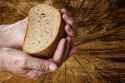 old-hands-holding-bread-38997950.jpg