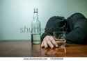stock-photo-drunk-man-lays-on-the-table-near-the-bottle-of-vodka-young-man-have-troubles-with-alcohol-man-372058009.jpg