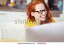 stock-photo-head-and-shoulders-of-young-woman-with-red-hair-wearing-eyeglasses-and-laughing-joyfully-while-385836151[1].jpg