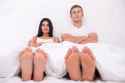 36619684-Funny-picture-of-young-couple-sitting-in-white-bed-with-their-feet-out-of-the-blanket-Stock-Photo.jpg