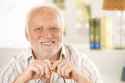 8748110-Portrait-of-happy-old-man-smiling-looking-at-camera--Stock-Photo.jpg