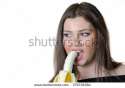stock-photo-cute-brunette-lady-wear-black-shirt-holding-and-eating-a-peeled-banana-379738384.jpg