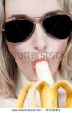 stock-photo-portrait-of-a-beautiful-sexy-blonde-girl-in-sunglasses-and-a-banana-in-his-mouth-on-a-white-281791961.jpg