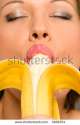 stock-photo-young-woman-eating-banana-3106254.jpg