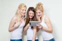 three-young-happy-women-looking-tablet-pc-laughing-two-blond-one-brunette-smiling-girls-studio-over-white-background-34980843.jpg