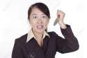 8213467-An-angry-Asian-businesswoman-holding-a-knife-Stock-Photo-angry-woman.jpg
