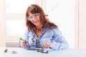 19293126-Beautiful-woman-in-protective-glasses-fixing-computer-parts-with-and-soldering-iron-and-other-tools-Stock-Photo.jpg