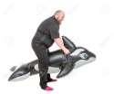55070909-Fat-Man-Fun-Jumping-on-an-Inflatable-Dolphin-isolated-on-white-background-Stock-Photo.jpg